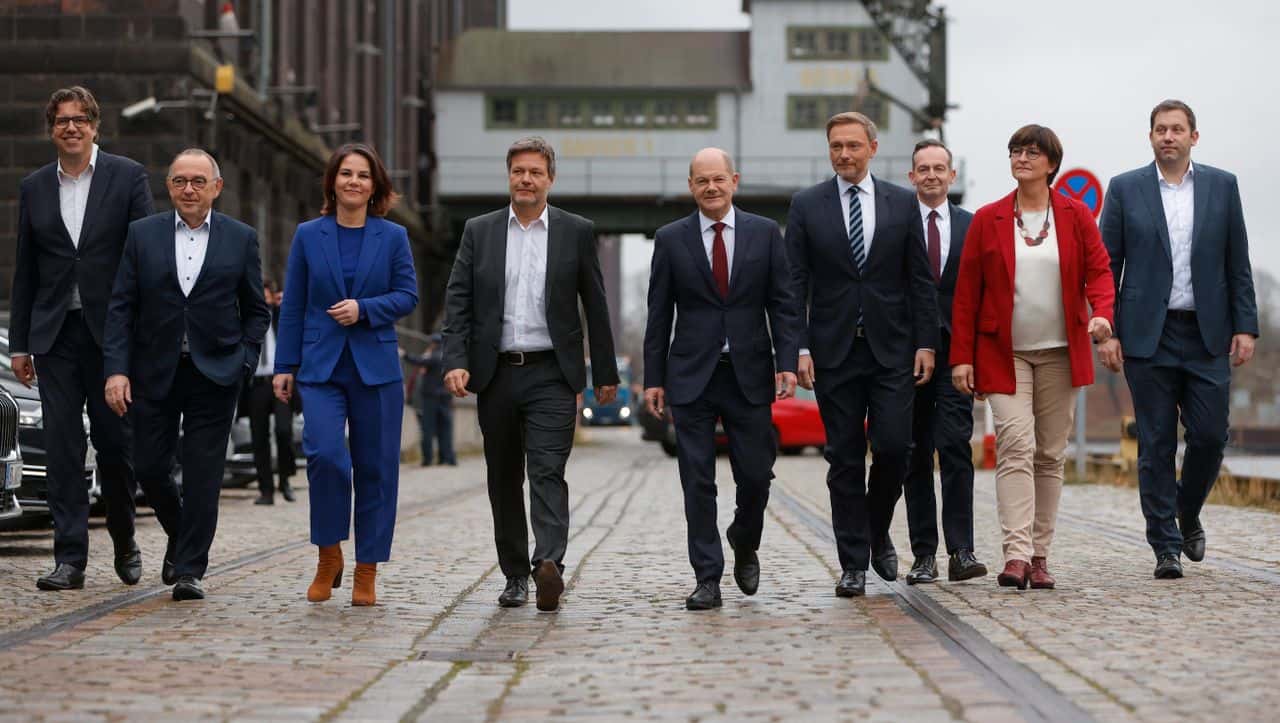 BERLIN, GERMANY - NOVEMBER 24: Norbert Walter-Borjans (2ndL) and Saskia Esken (2ndR), co-leaders of the German Social Democrats (SPD), Olaf Scholz (C), SPD member and likely next German chancellor, Annalene Baerbock (3rdL) and Robert Habeck (4thL), co-leaders of the Greens Party, and Christian Lindner (4thR), leader of the German Free Democrats (FDP), with Volker Wissing (3rdR), General Secretary of the German Free Democrats (FDP), Lars Klingbeil (R), General Secretary of the German Social Democrats (SPD), Michael Kellner (L), Federal Managing Director of the Greens Party, present their mutually-agreed on coalition contract on November 24, 2021 in Berlin, Germany. The contract establishes the policy framework for the three parties to create the next federal coalition government. The three parties have been in coalition negotiations over the weeks following federal parliamentary elections last September. (Photo by Michele Tantussi/Getty Images)